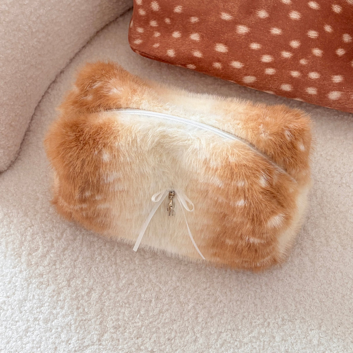 Bichelle Deer Charm Beauty Bag - styled on a cream chair