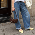 Briochelle Polka Dot Croissant Shoulder Bag - Chocolate Brown - carried with wide-leg jeans
