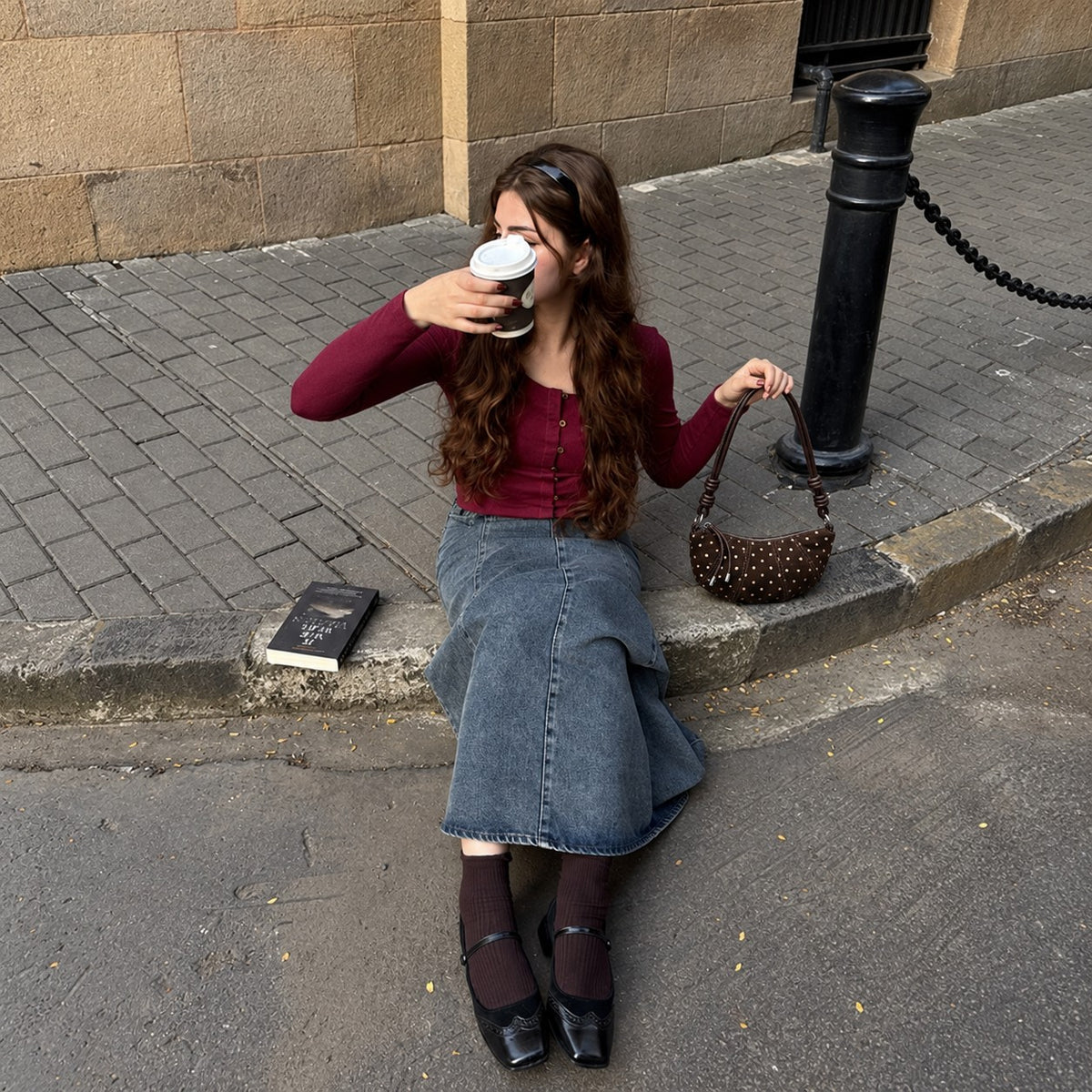 Briochelle Polka Dot Croissant Shoulder Bag - Chocolate Brown - sitting on the curb with coffee