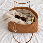 Daimée Suede-Look Shoulder Bag - Khaki - open on the bed with everyday essentials