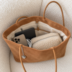 Daimée Suede-Look Shoulder Bag - Khaki - on a bouclé armchair