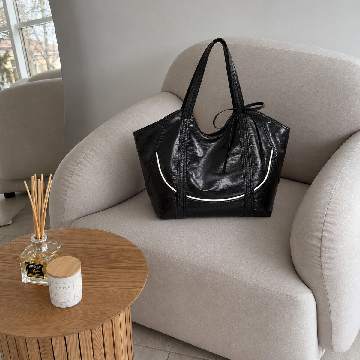 Clovara Glossy Tote Bag - Black - styled on an armchair