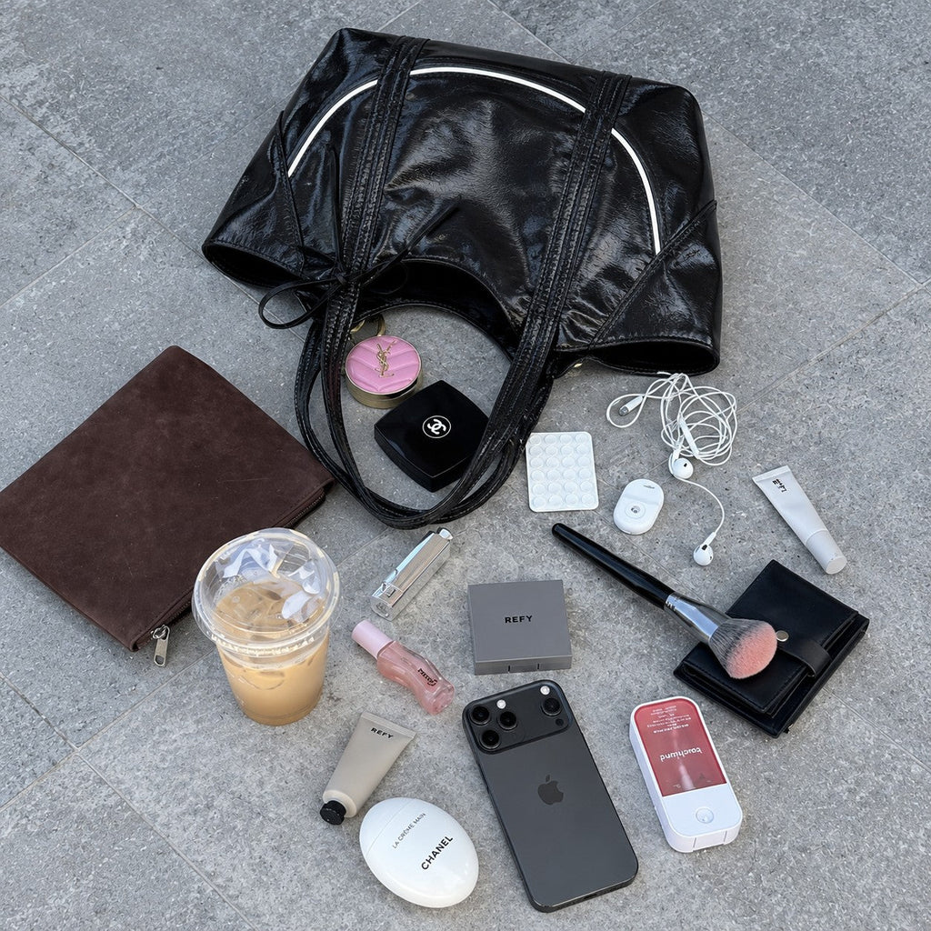 Clovara Glossy Tote Bag - Black - with makeup and essentials flat lay