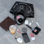 Clovara Glossy Tote Bag - Black - with makeup and essentials flat lay