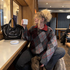 Clovara Glossy Tote Bag - Black - on a cafe counter