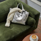 Clovara Glossy Tote Bag - Silver - on a green velvet sofa