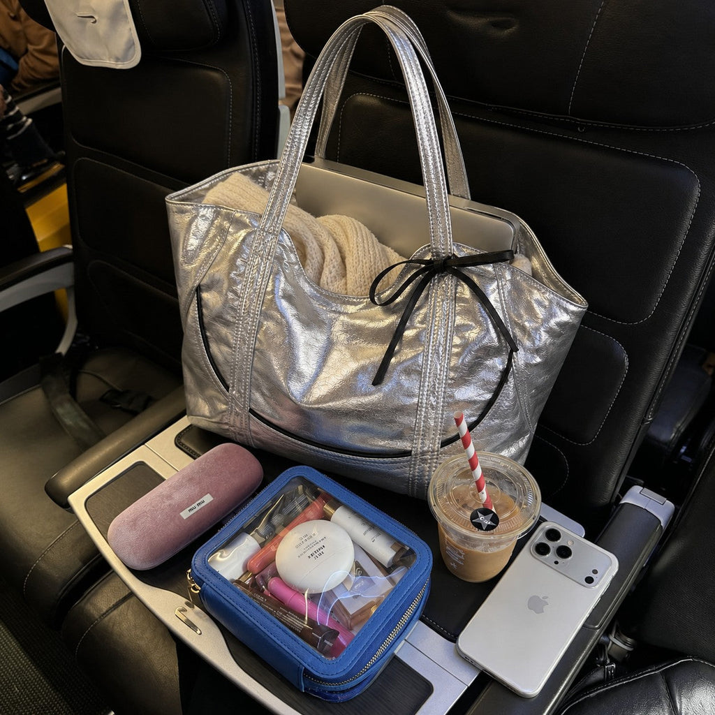 Clovara Glossy Tote Bag - Silver - packed for travel on a plane seat