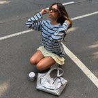Clovara Glossy Tote Bag - Silver - on the street beside the model