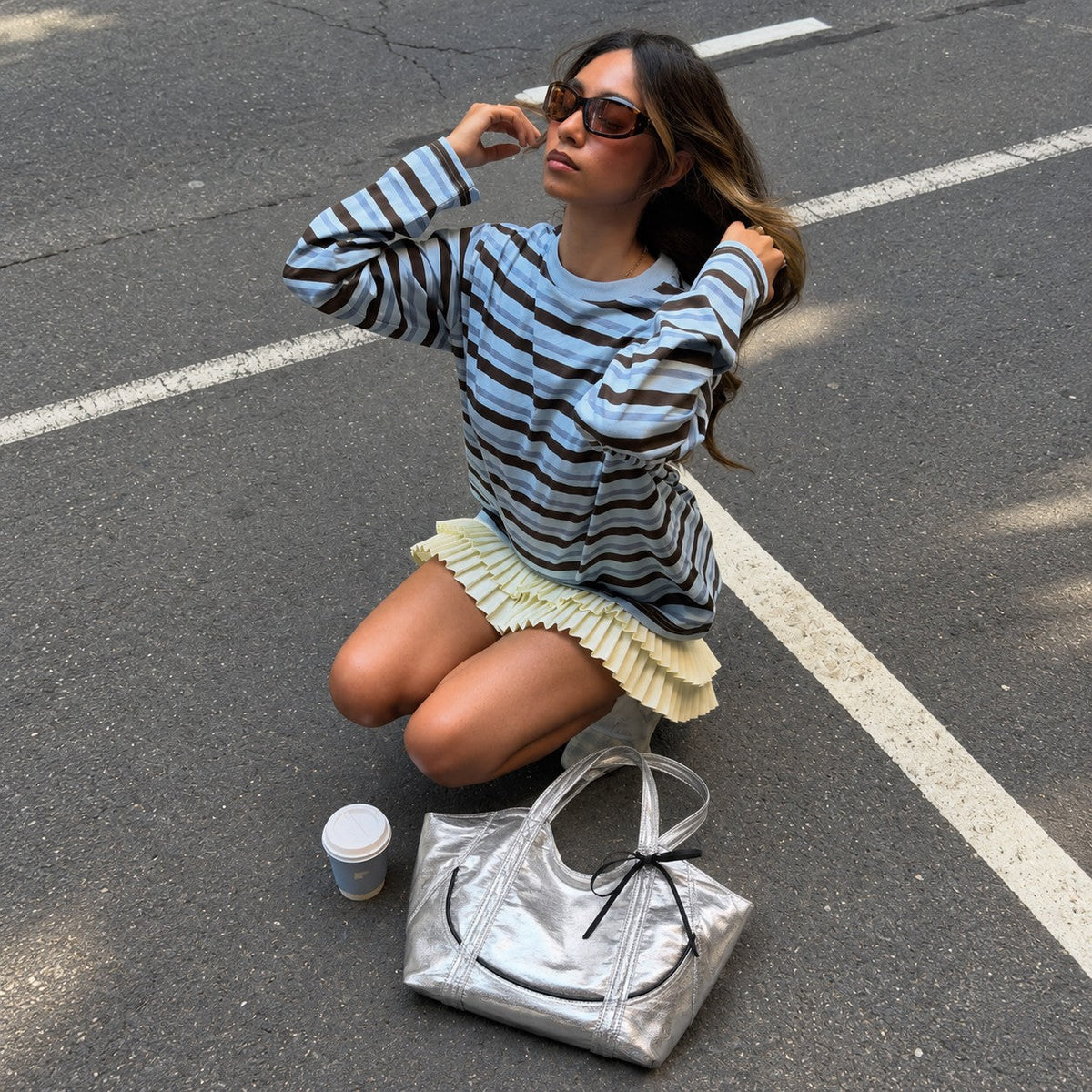 Clovara Glossy Tote Bag - Silver - on the street beside the model