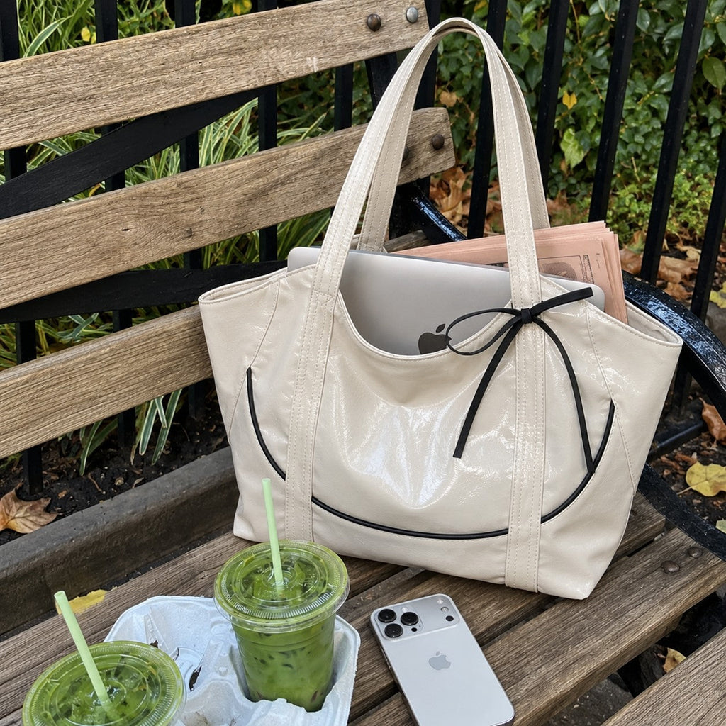 Clovara Glossy Tote Bag - White - on a bench with a laptop and iced matcha