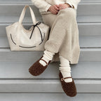Clovara Glossy Tote Bag - White - beside a knit skirt on the steps
