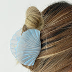 Conchelle Glossy Shell Hair Claw Clip - worn in a bun in Blue