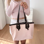 Confetta Buckle Strap Nylon Tote Bag - held in hand in Baby Pink