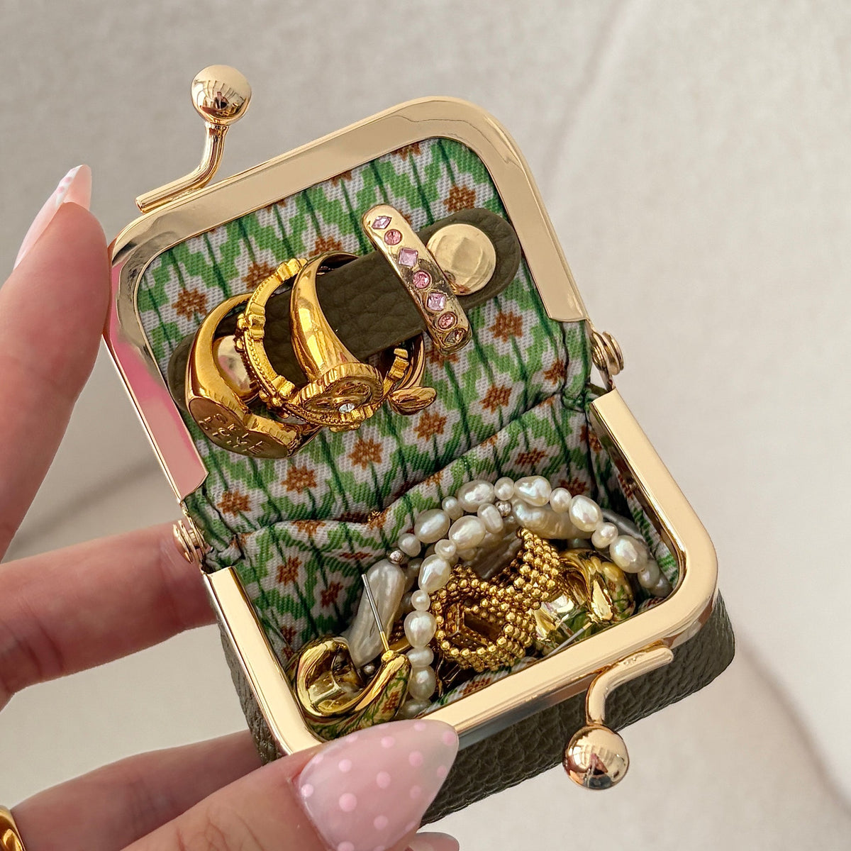 Écrinette Kiss-Lock Jewelry Case - open in hand in Olive Green