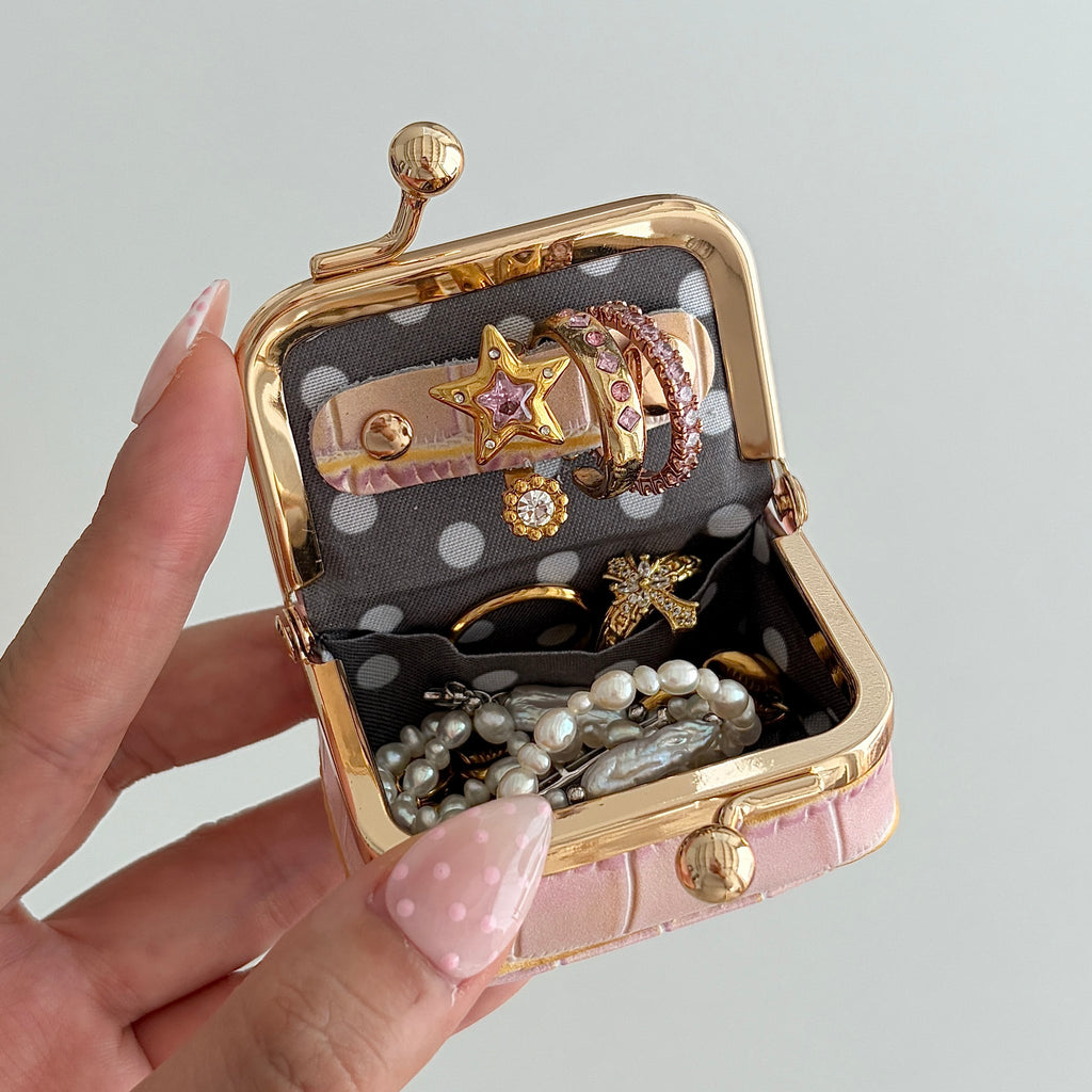 Écrinette Kiss-Lock Jewelry Case - open in hand in Blush Mauve