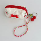 Orchard Swing Beaded Cherry Phone Charm - clipped to a quilted coin pouch