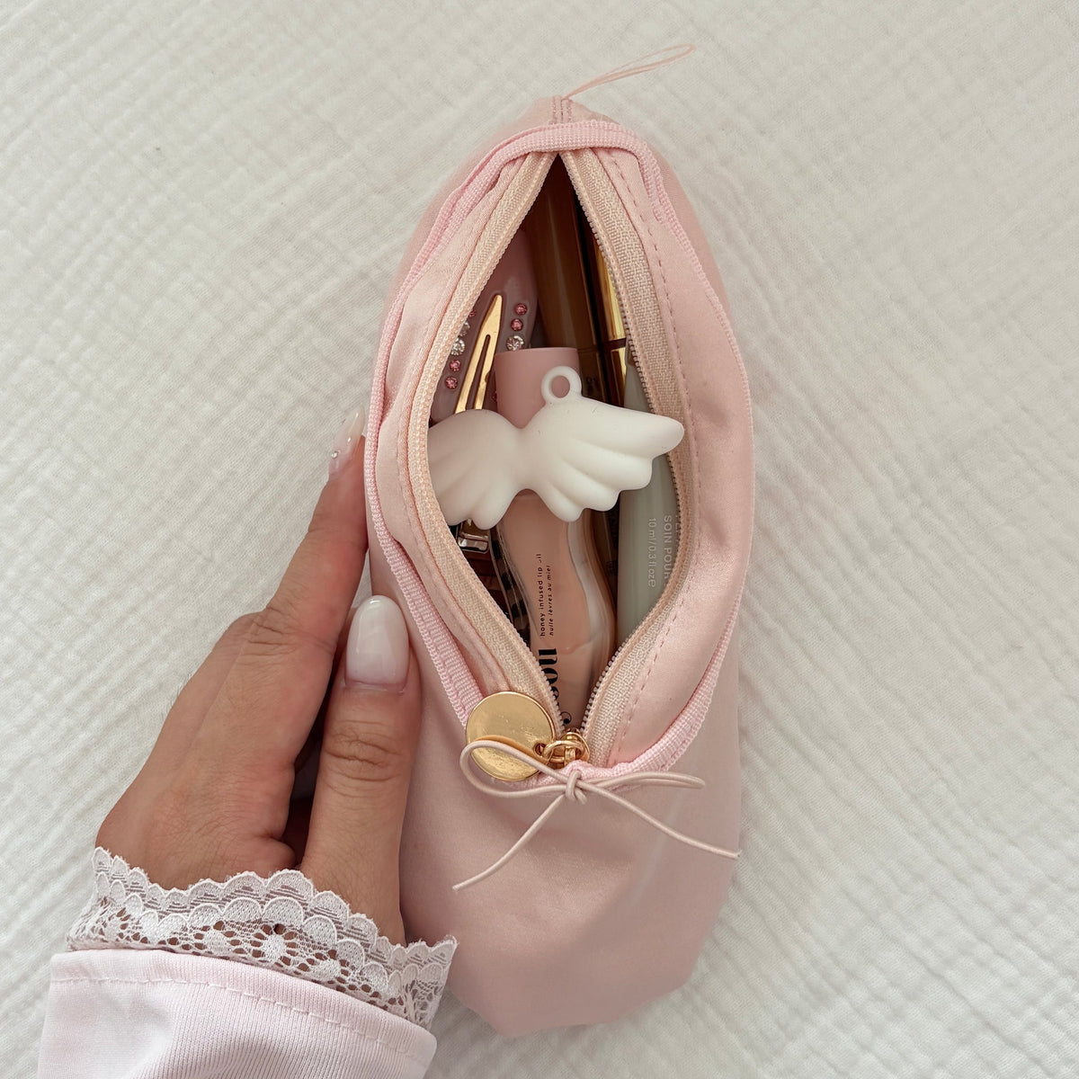 Sylphine Satin Ballet Makeup Pouch - held in hand, open with makeup